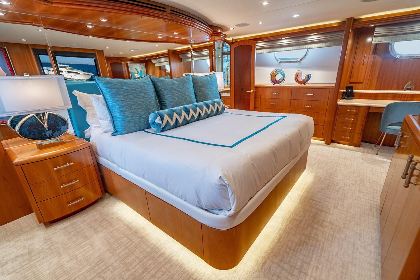 a bedroom with a bed and desk aboard INEVITABLE Yacht for Sale