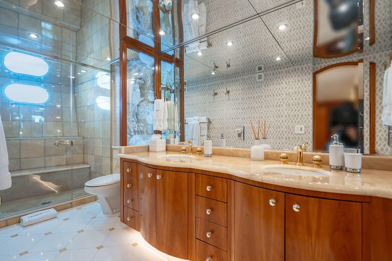 a bathroom with a glass shower aboard INEVITABLE Yacht for Sale