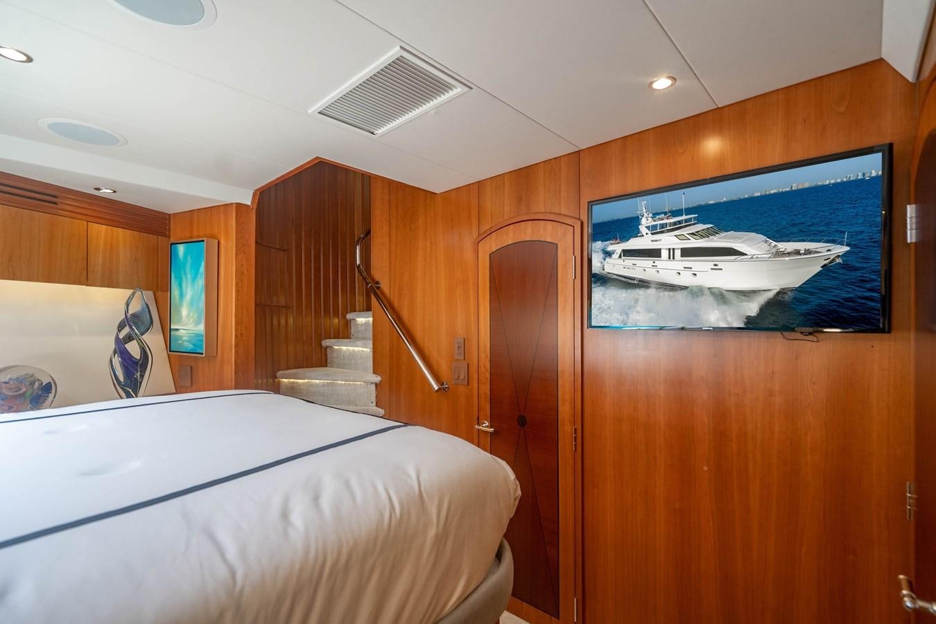 a room with a bed and a television aboard INEVITABLE Yacht for Sale