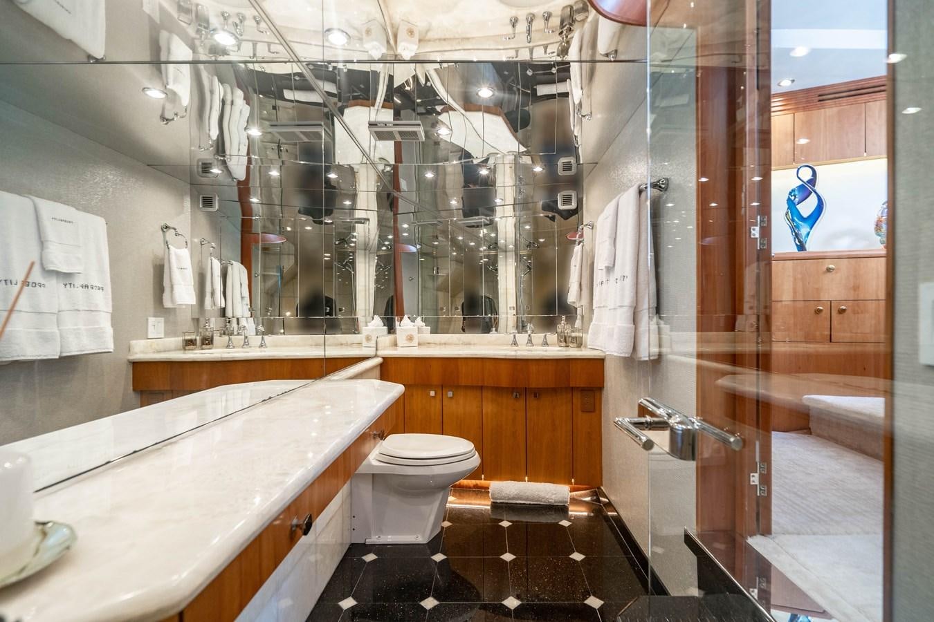 a bathroom with a tub sink and toilet aboard INEVITABLE Yacht for Sale