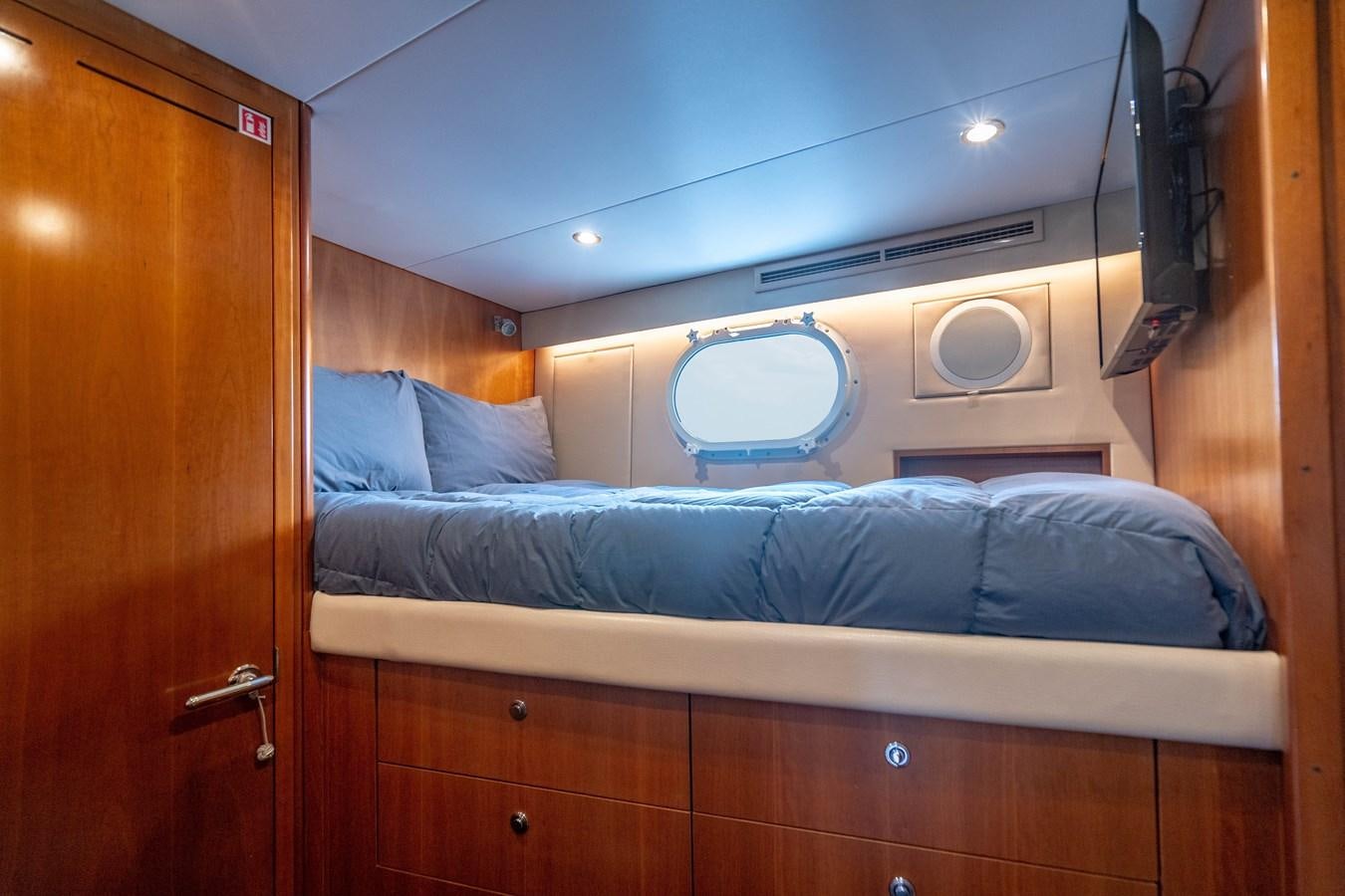 a bed with a blue cover aboard INEVITABLE Yacht for Sale