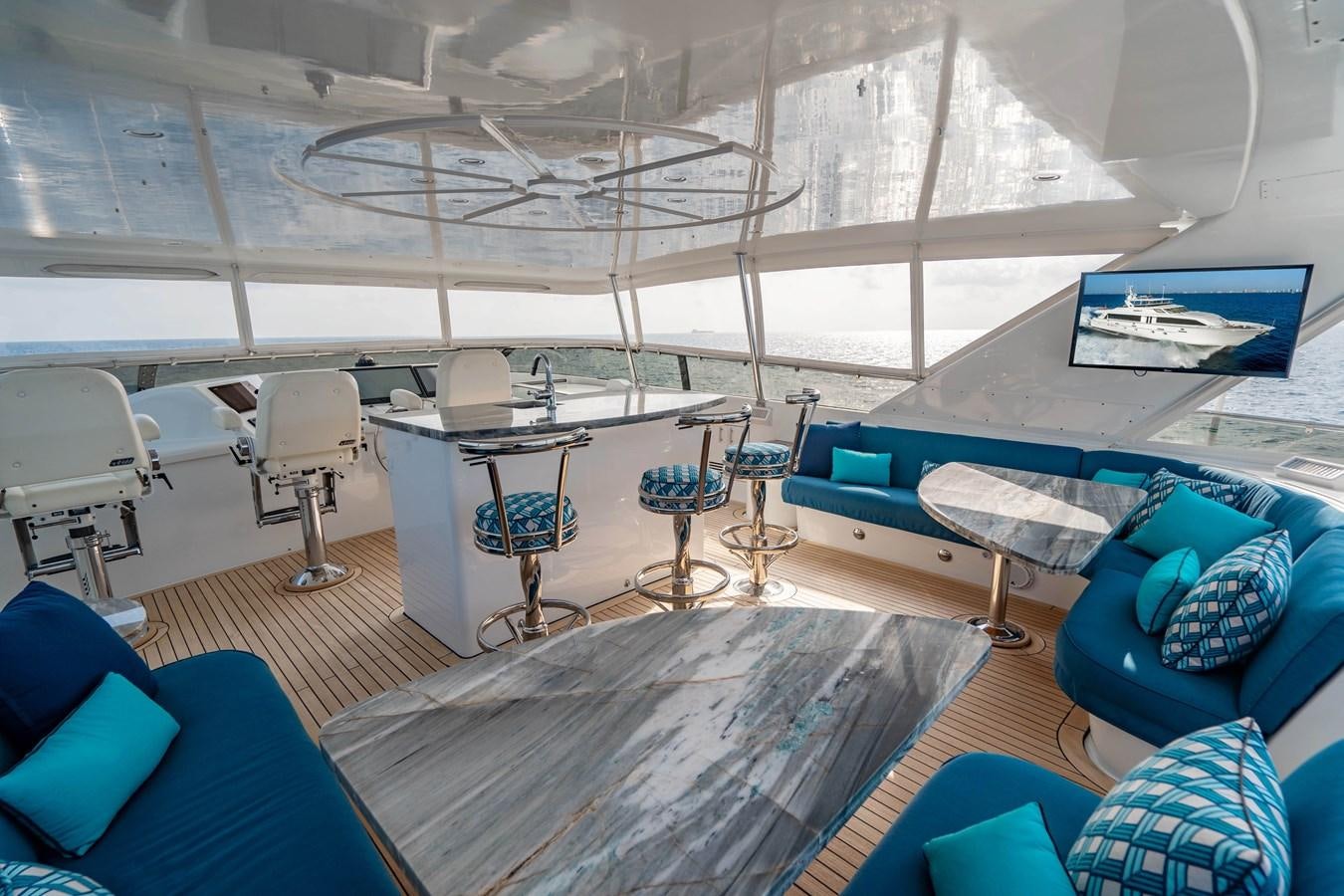 a room with a table chairs and a couch aboard INEVITABLE Yacht for Sale