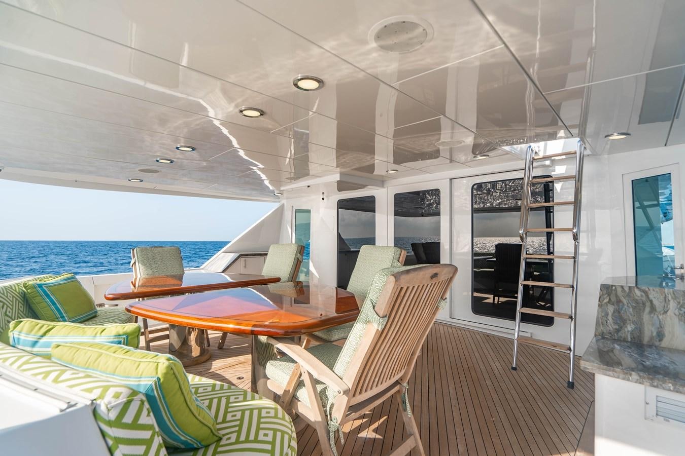 a boat with a table and chairs aboard INEVITABLE Yacht for Sale