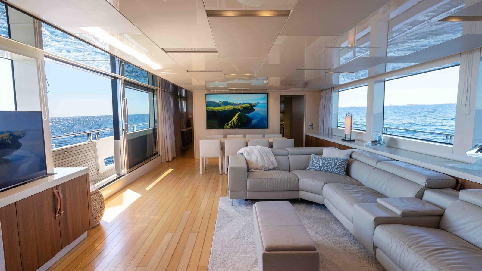 a living room with a large window aboard 106 FLYBRIDGE Yacht for Sale