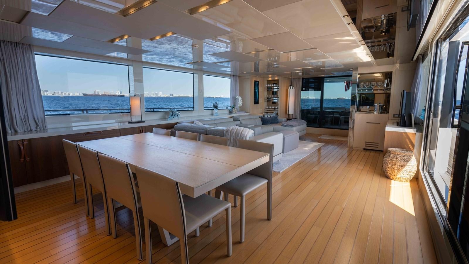 a room with a table and chairs aboard 106 FLYBRIDGE Yacht for Sale