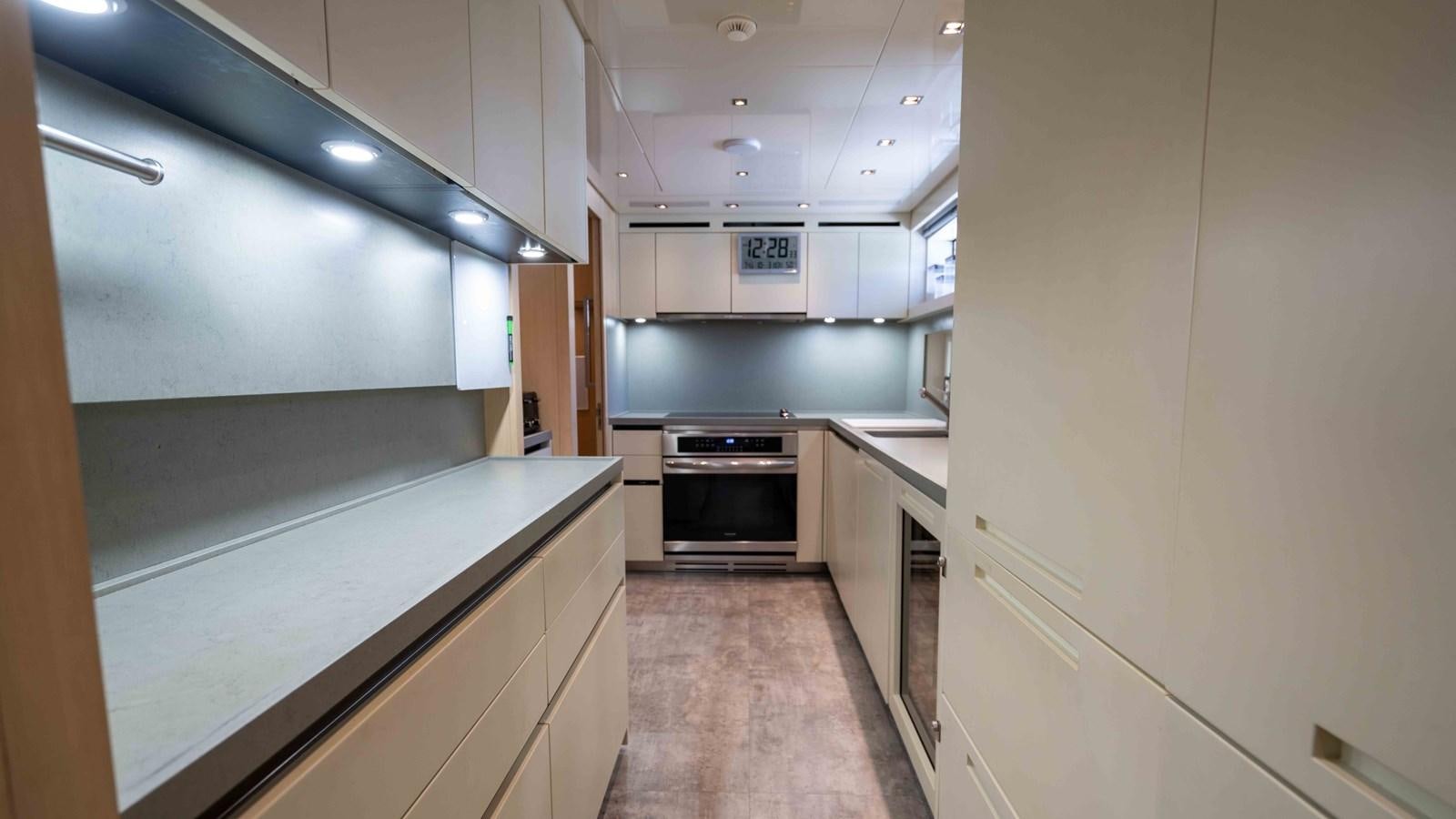 a kitchen with white cabinets aboard 106 FLYBRIDGE Yacht for Sale