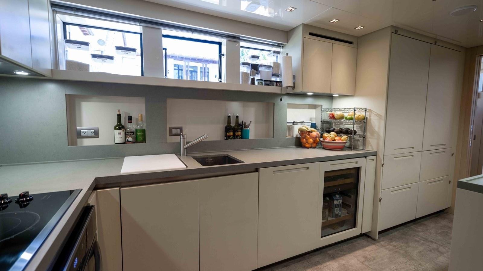 a kitchen with white cabinets aboard 106 FLYBRIDGE Yacht for Sale