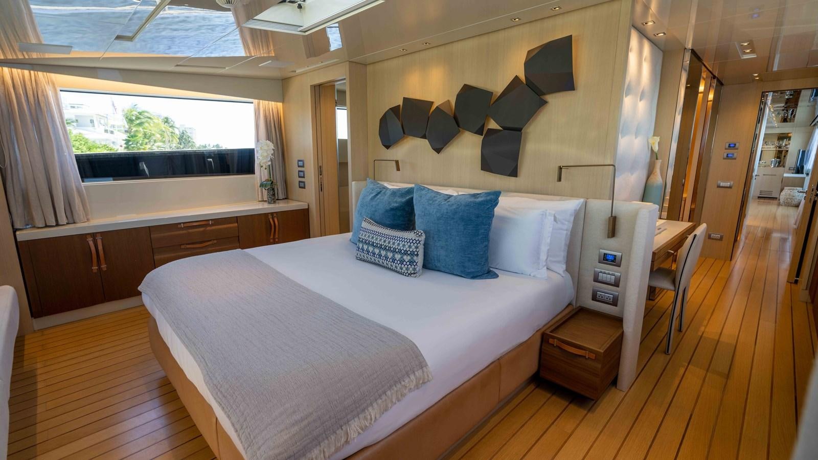 a room with a bed and a desk aboard 106 FLYBRIDGE Yacht for Sale