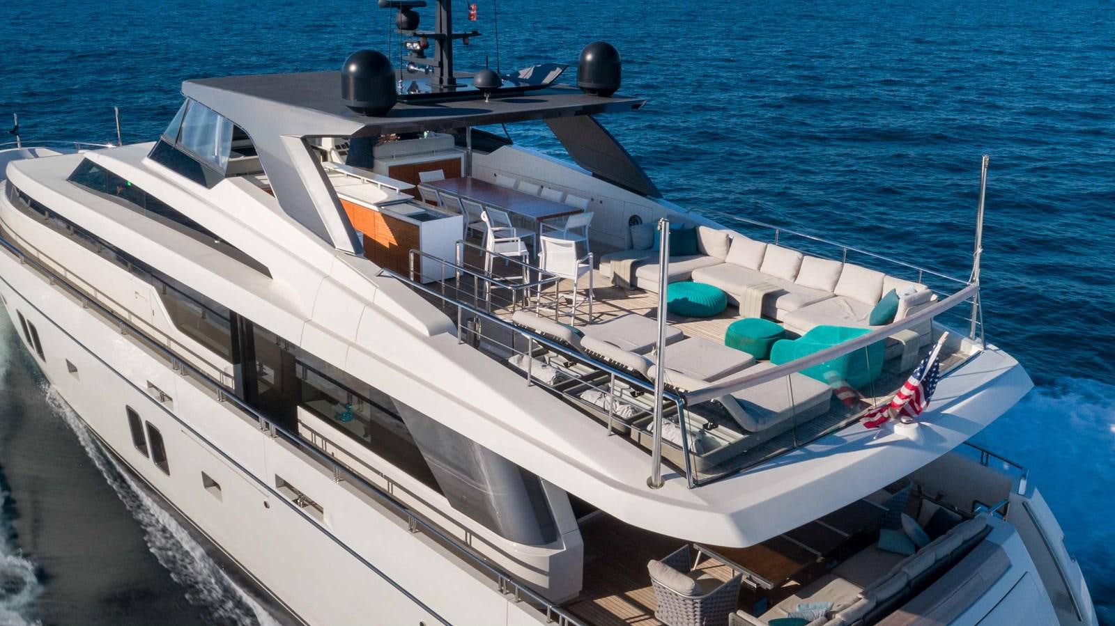 a white boat with a person on it aboard 106 FLYBRIDGE Yacht for Sale