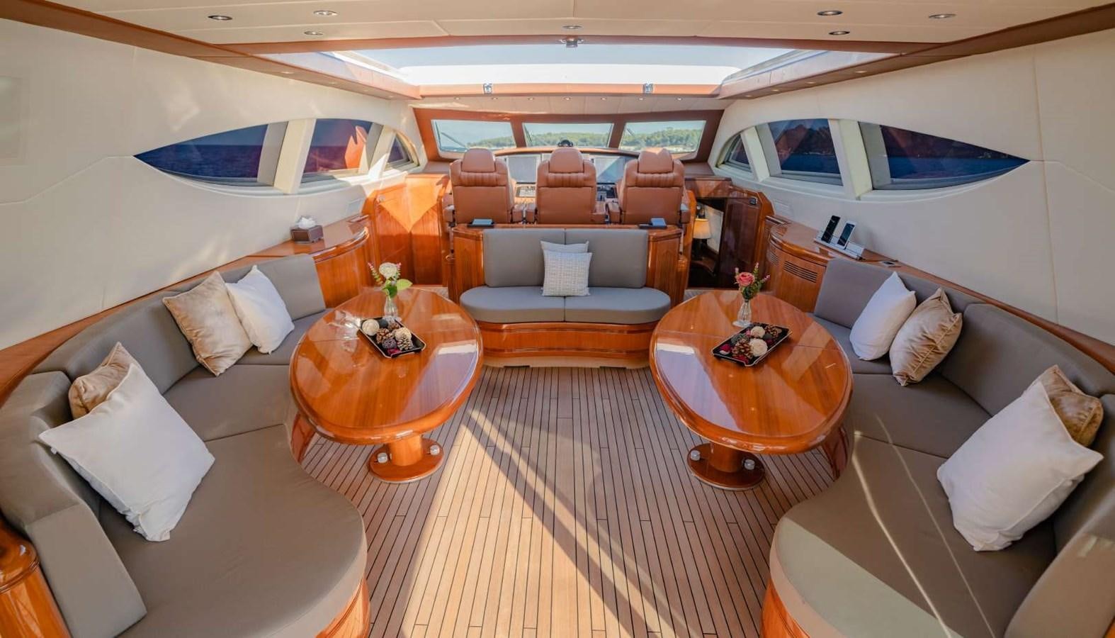 a living room with a couch and a table aboard STORM Yacht for Sale