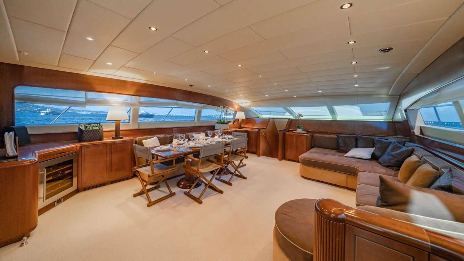 a living room with a couch and a table aboard STORM Yacht for Sale