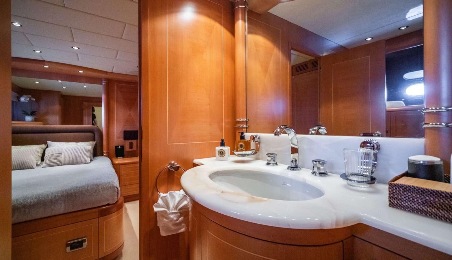 a bathroom with a sink and a bed aboard STORM Yacht for Sale