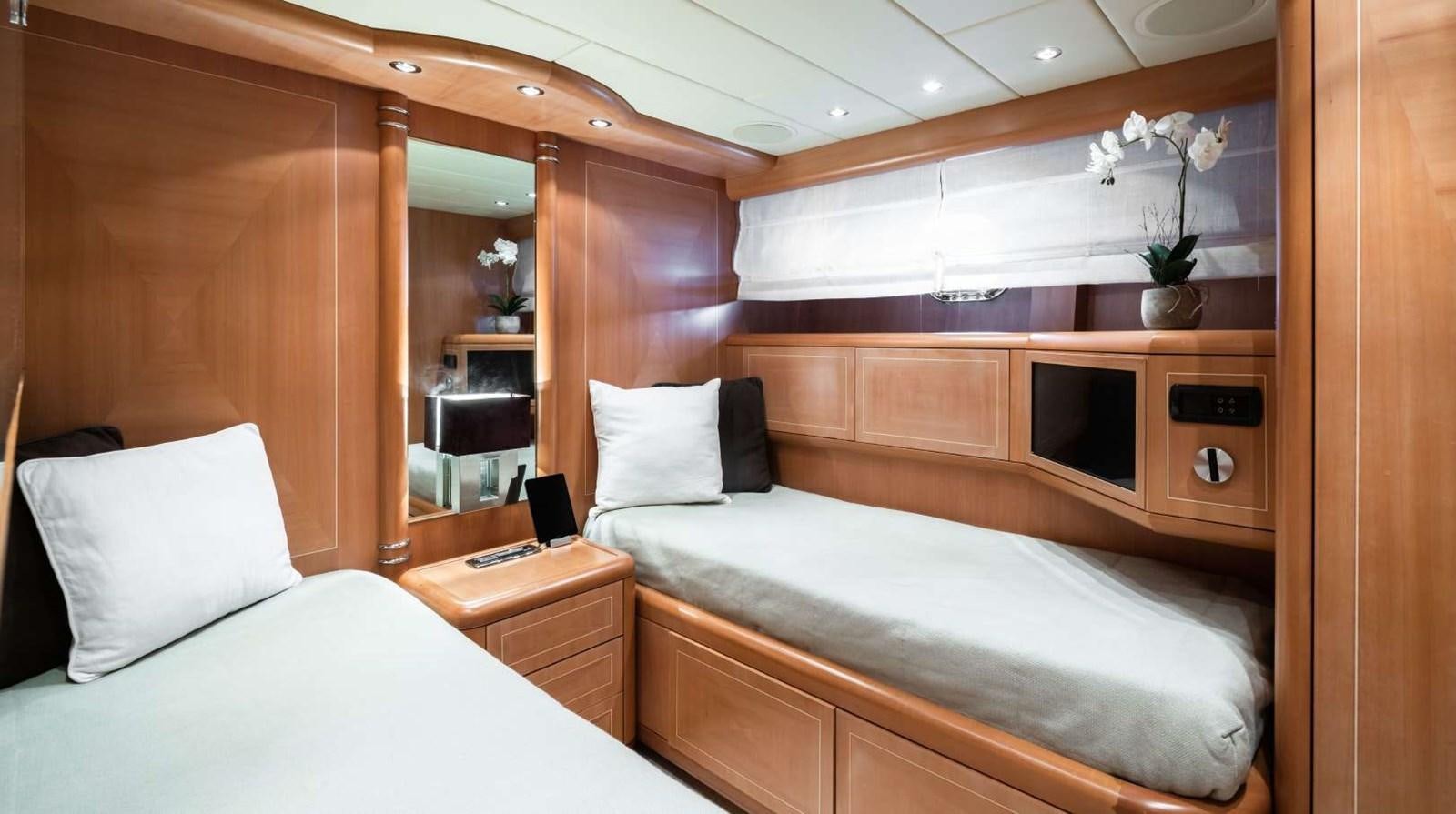 a room with a bed and a desk aboard STORM Yacht for Sale