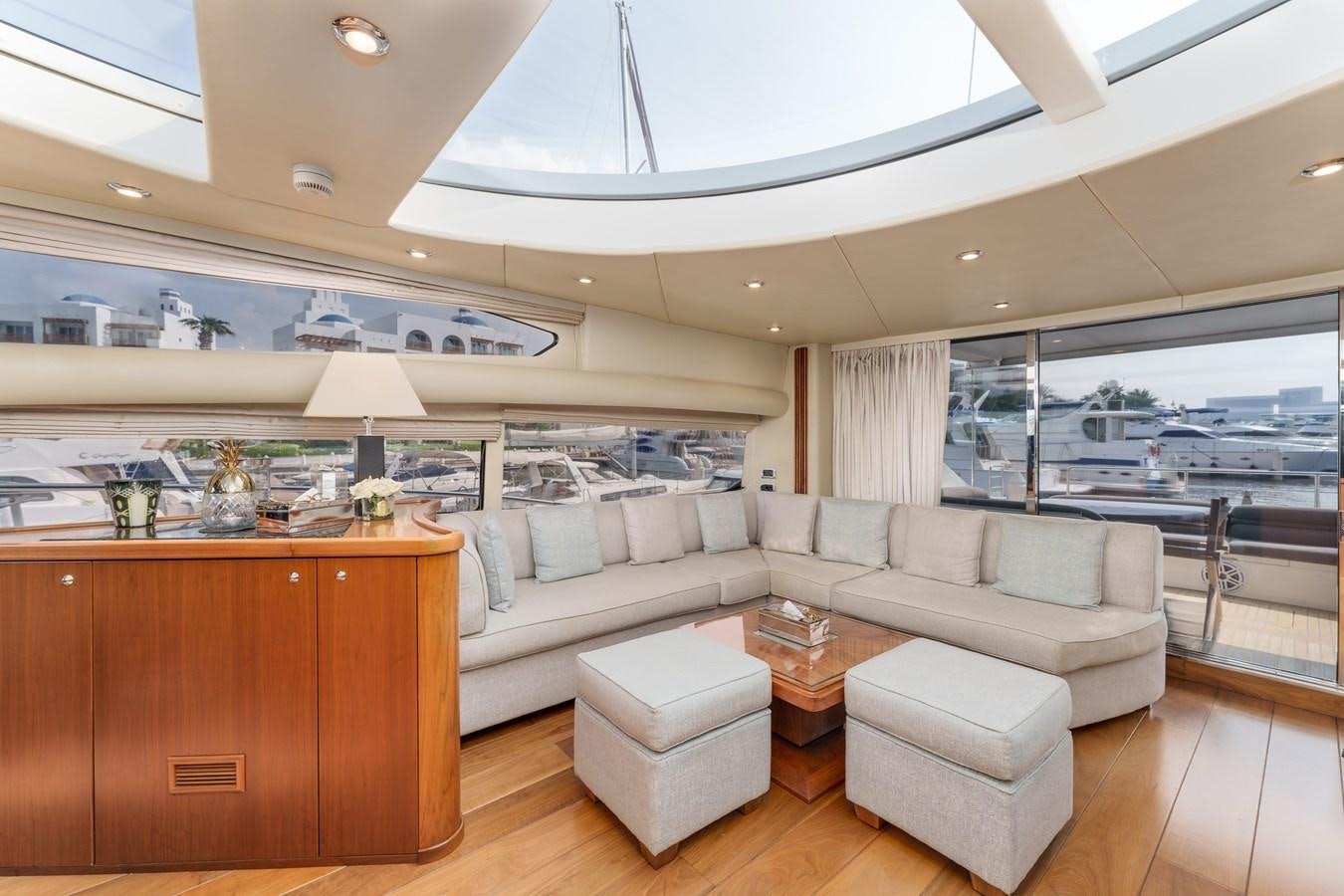 a living room with a large window aboard MILA DUBAI Yacht for Sale