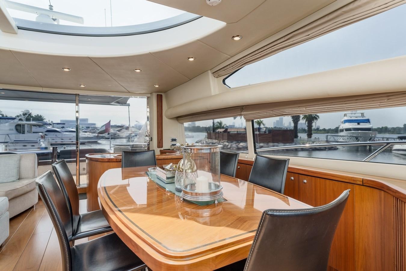 a table with chairs and a glass on it aboard MILA DUBAI Yacht for Sale