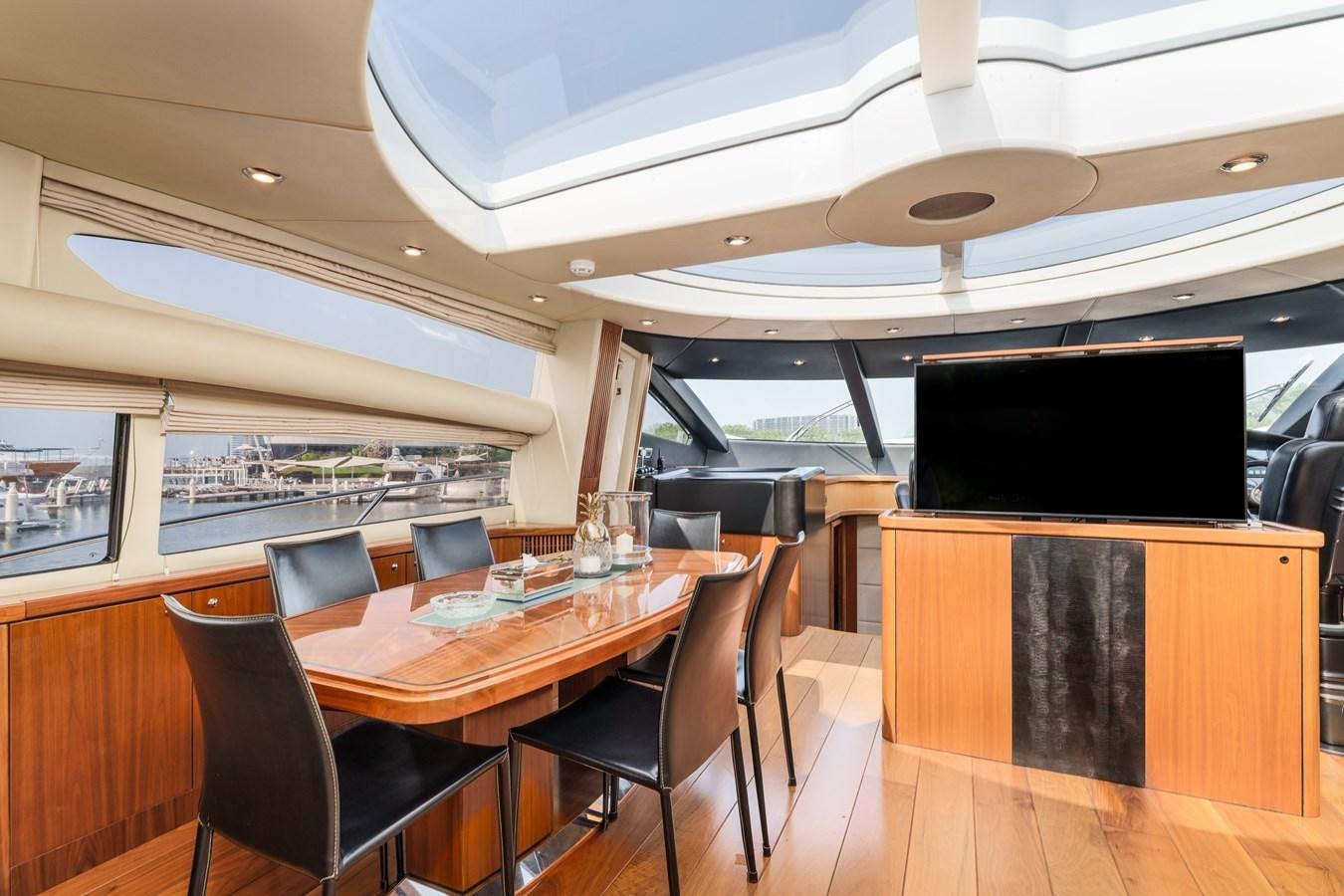 a room with a table and chairs aboard MILA DUBAI Yacht for Sale