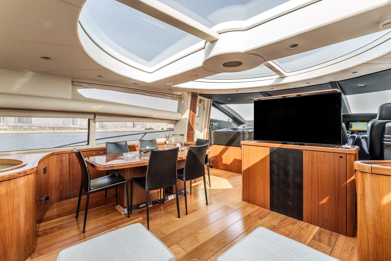 a room with a table and chairs aboard MILA DUBAI Yacht for Sale