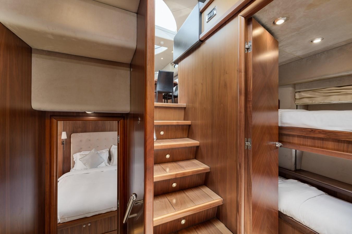 a room with wooden furniture aboard MILA DUBAI Yacht for Sale