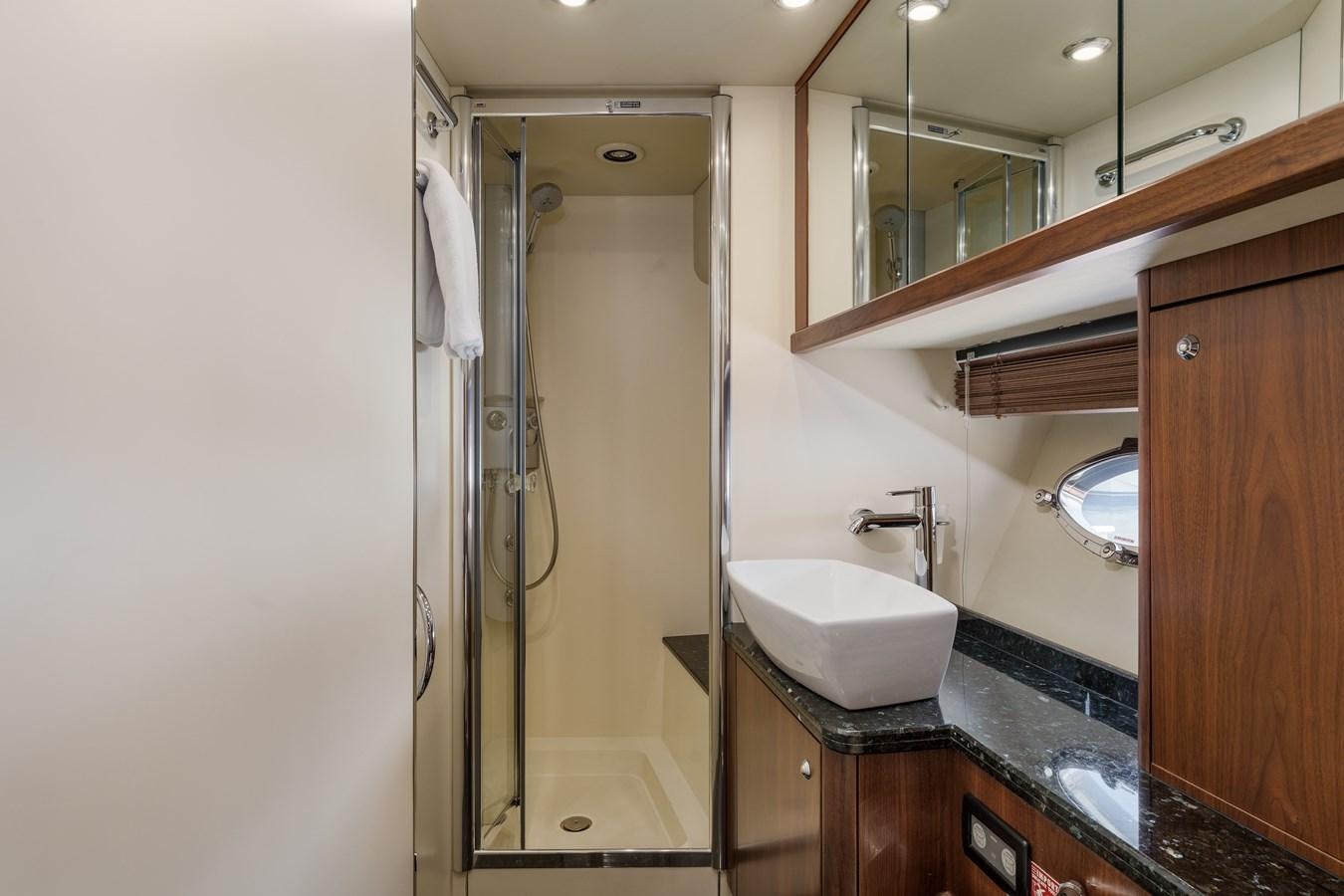 a bathroom with a glass shower aboard MILA DUBAI Yacht for Sale