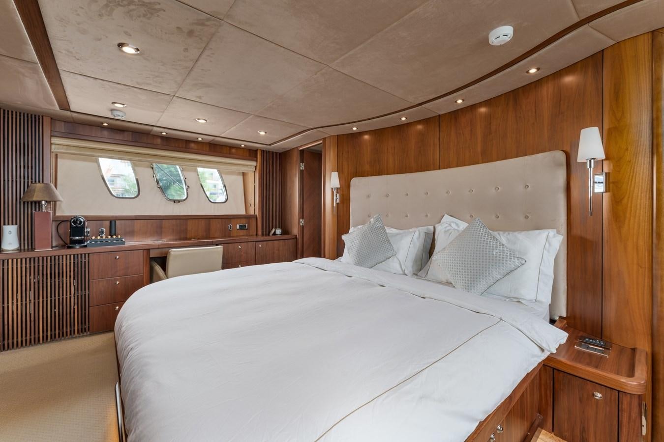 a bed with white sheets aboard MILA DUBAI Yacht for Sale