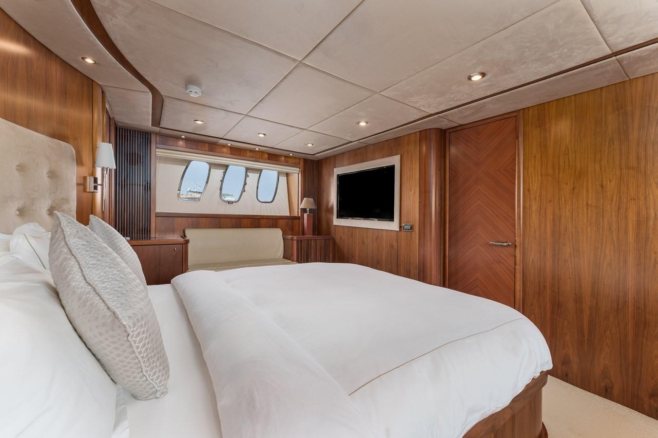 a room with a bed and a television aboard MILA DUBAI Yacht for Sale