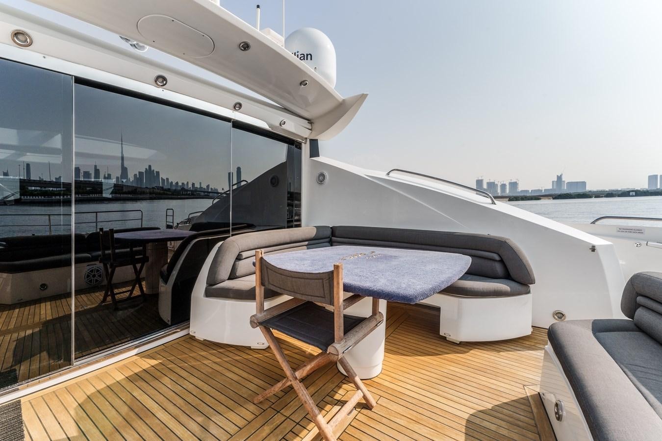 a room with a bed and a table aboard MILA DUBAI Yacht for Sale