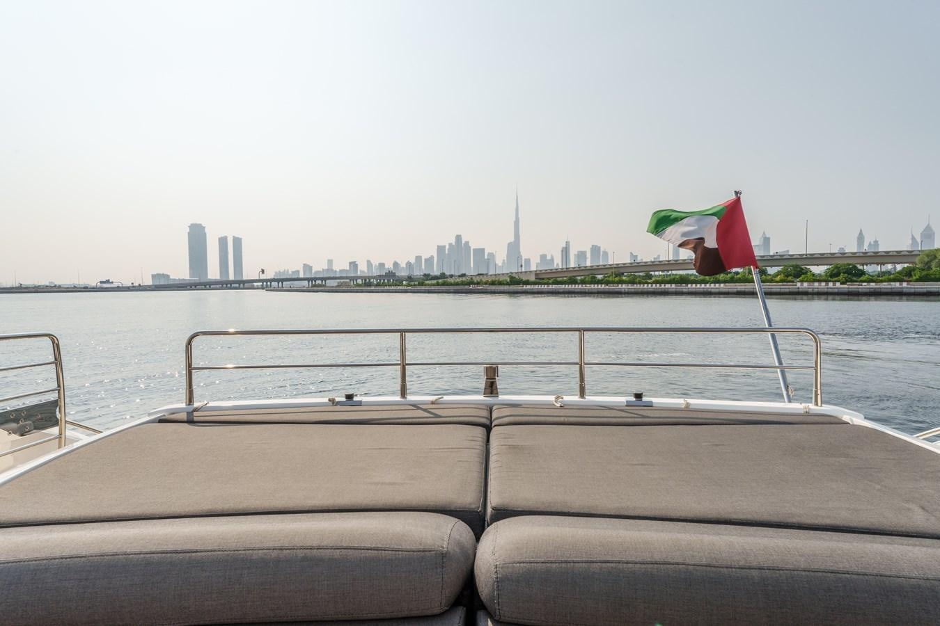 a boat with a flag on it aboard MILA DUBAI Yacht for Sale