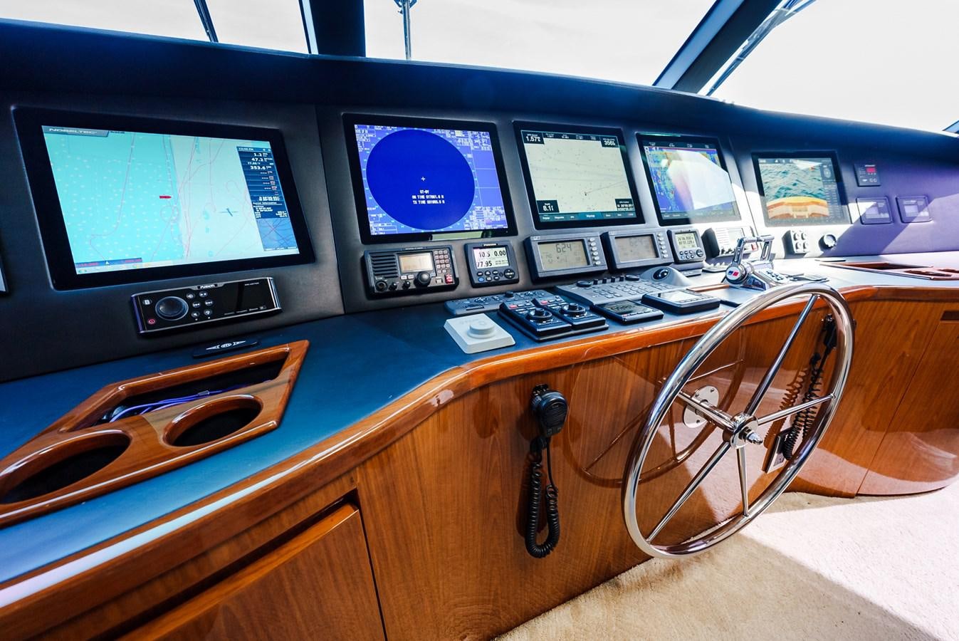 a desk with a computer and other electronic devices on it aboard PANACEA Yacht for Sale