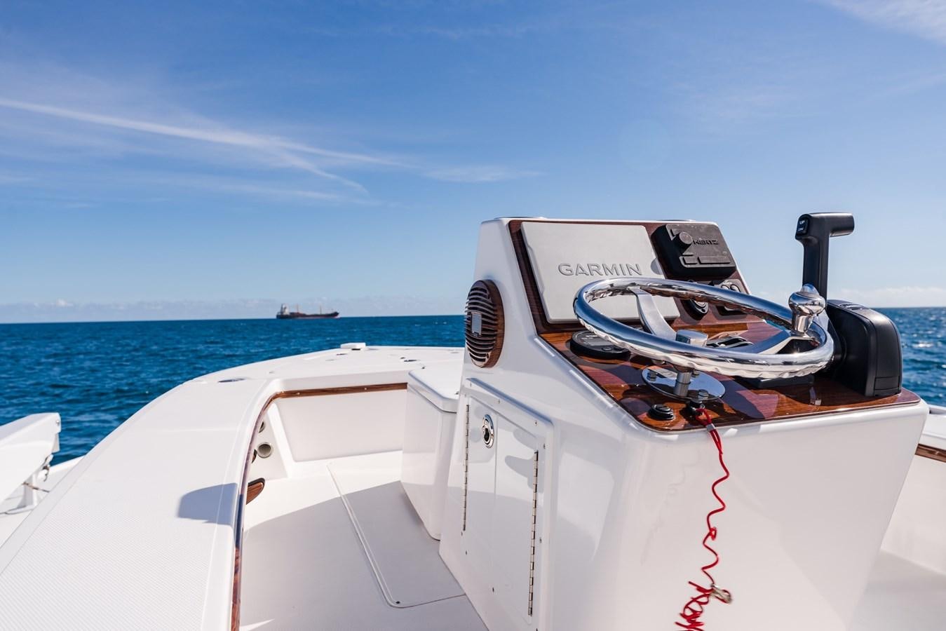 a speed boat with a steering wheel aboard PANACEA Yacht for Sale