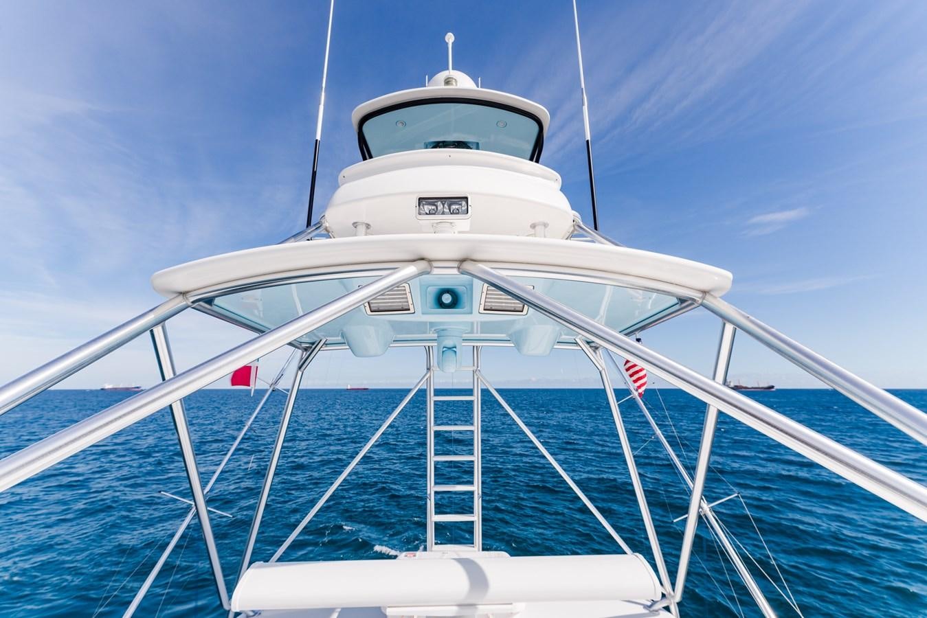 a white boat with a flag on it aboard PANACEA Yacht for Sale