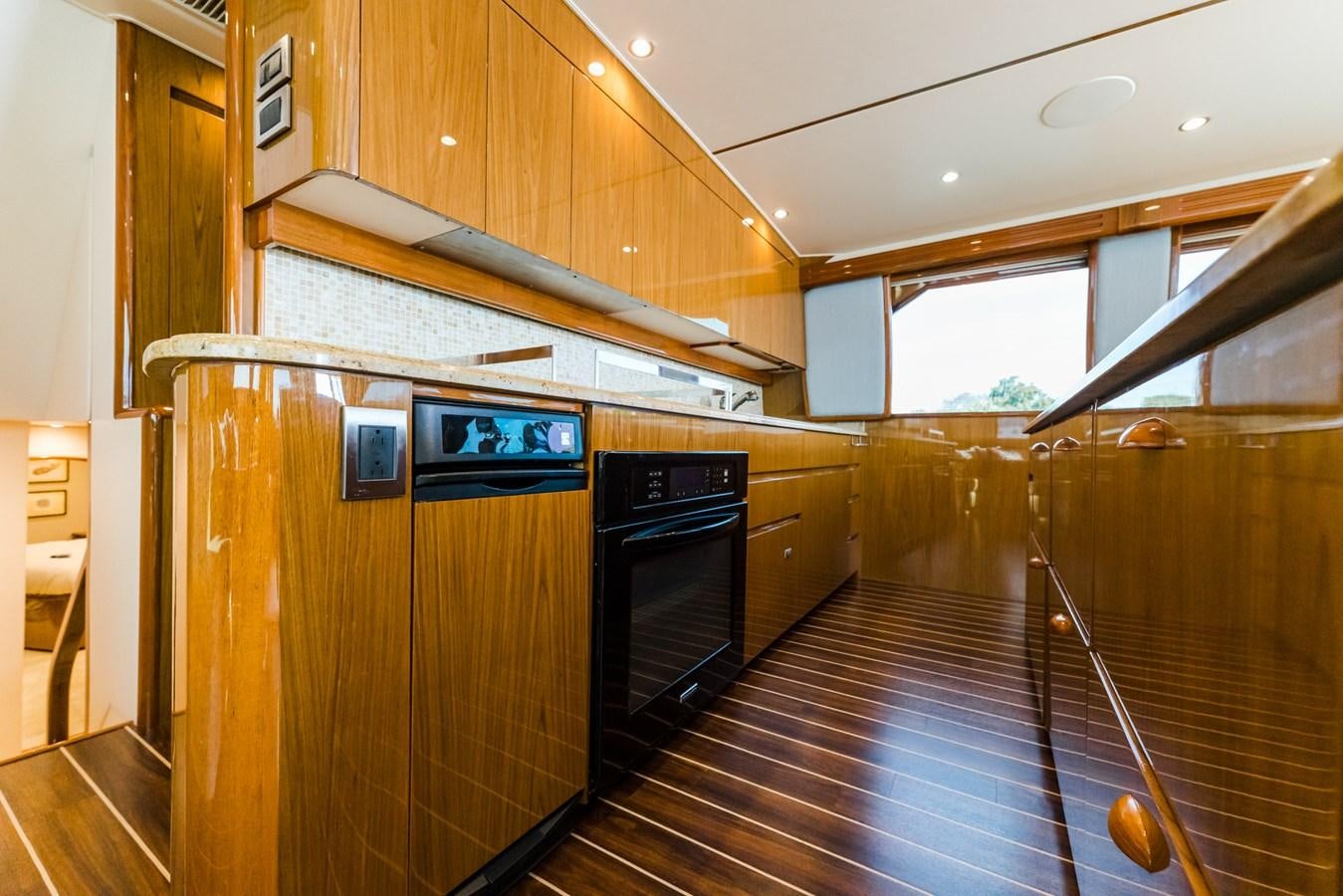 a kitchen with wooden cabinets aboard PANACEA Yacht for Sale