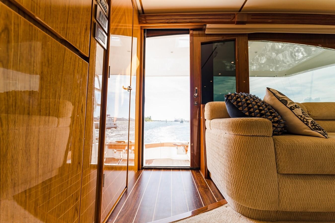 a wood cabin with a couch and a wood door aboard PANACEA Yacht for Sale