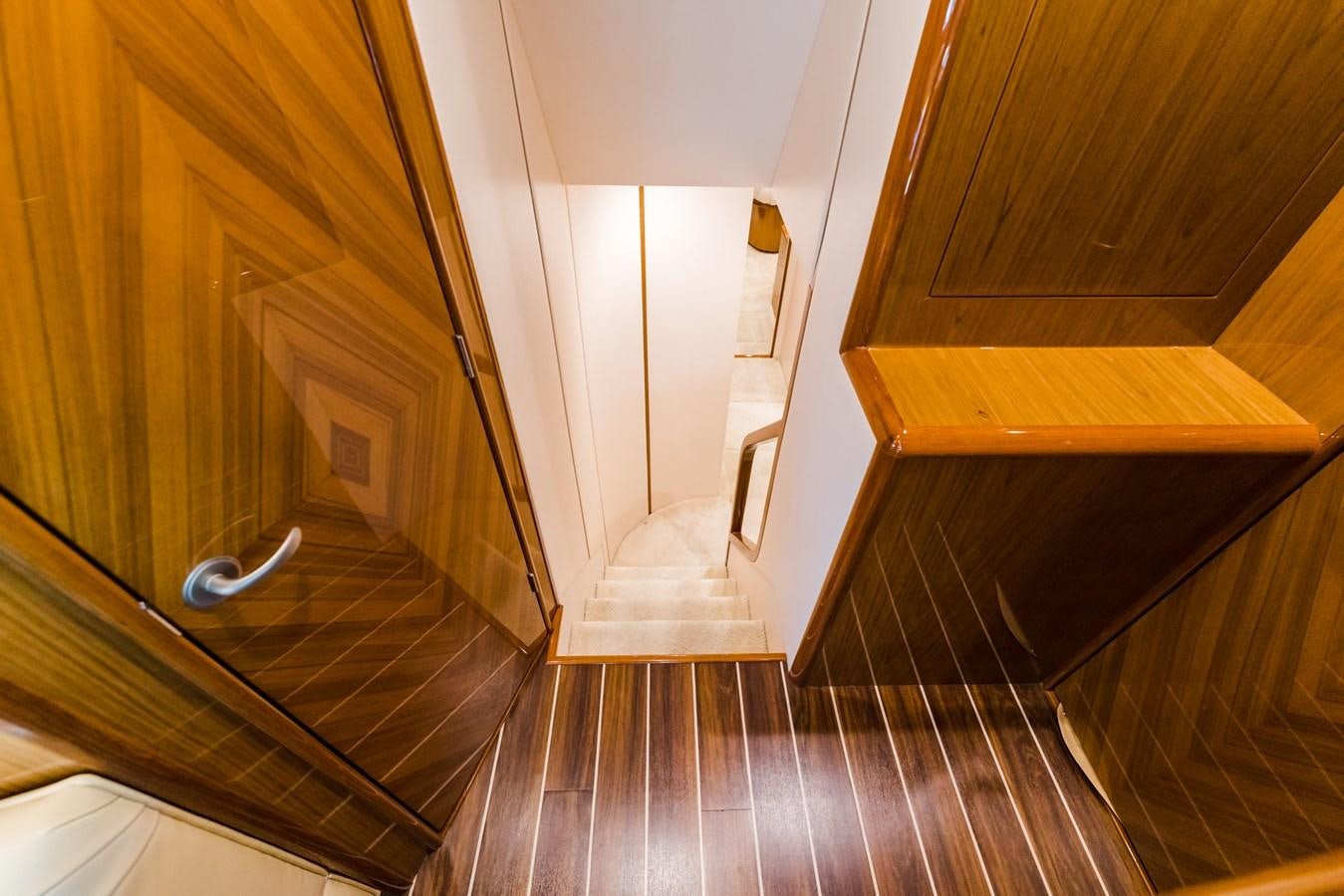 a wooden staircase with a wood railing aboard PANACEA Yacht for Sale