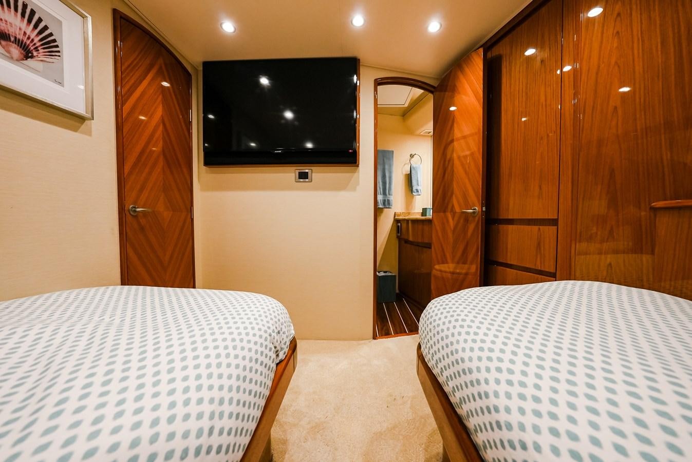 a hotel room with a tv and bed aboard PANACEA Yacht for Sale