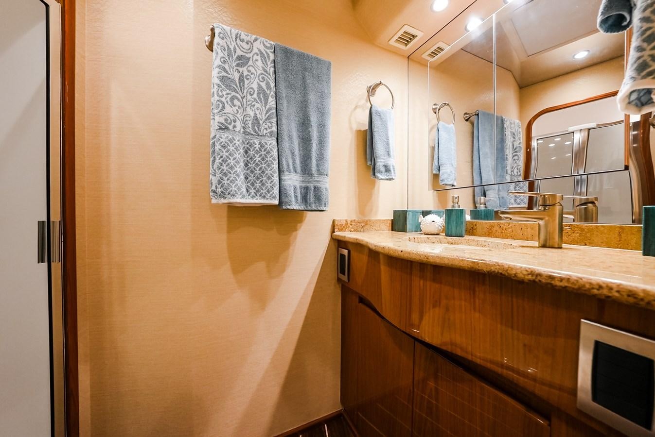 a bathroom with a countertop sink and towels aboard PANACEA Yacht for Sale