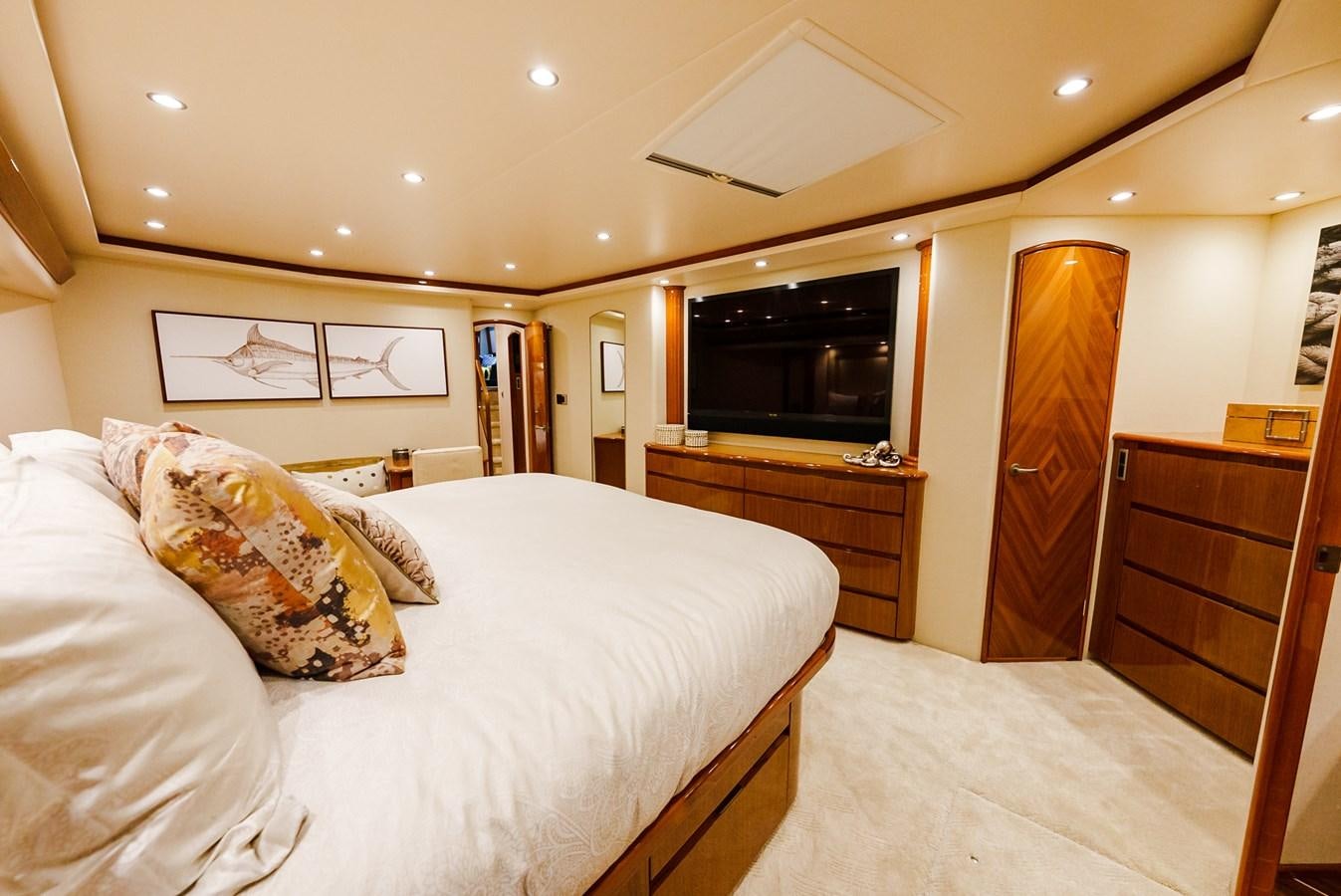 a bedroom with a bed and a television aboard PANACEA Yacht for Sale