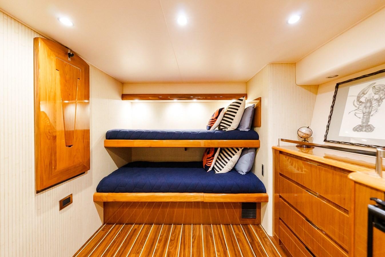 a bedroom with a blue bed aboard PANACEA Yacht for Sale