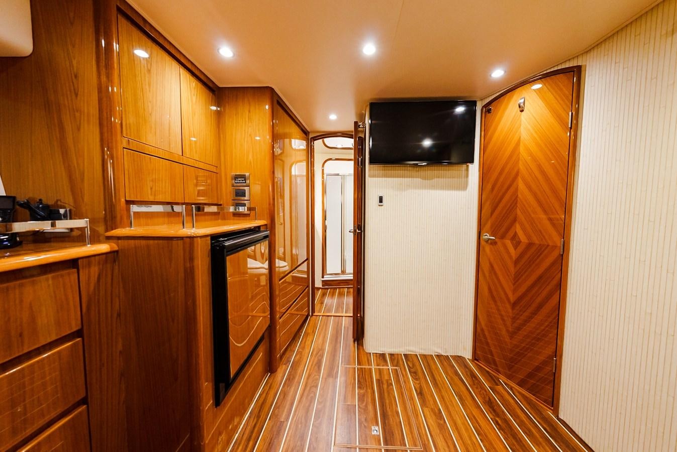 a room with wooden cabinets and a wood floor aboard PANACEA Yacht for Sale