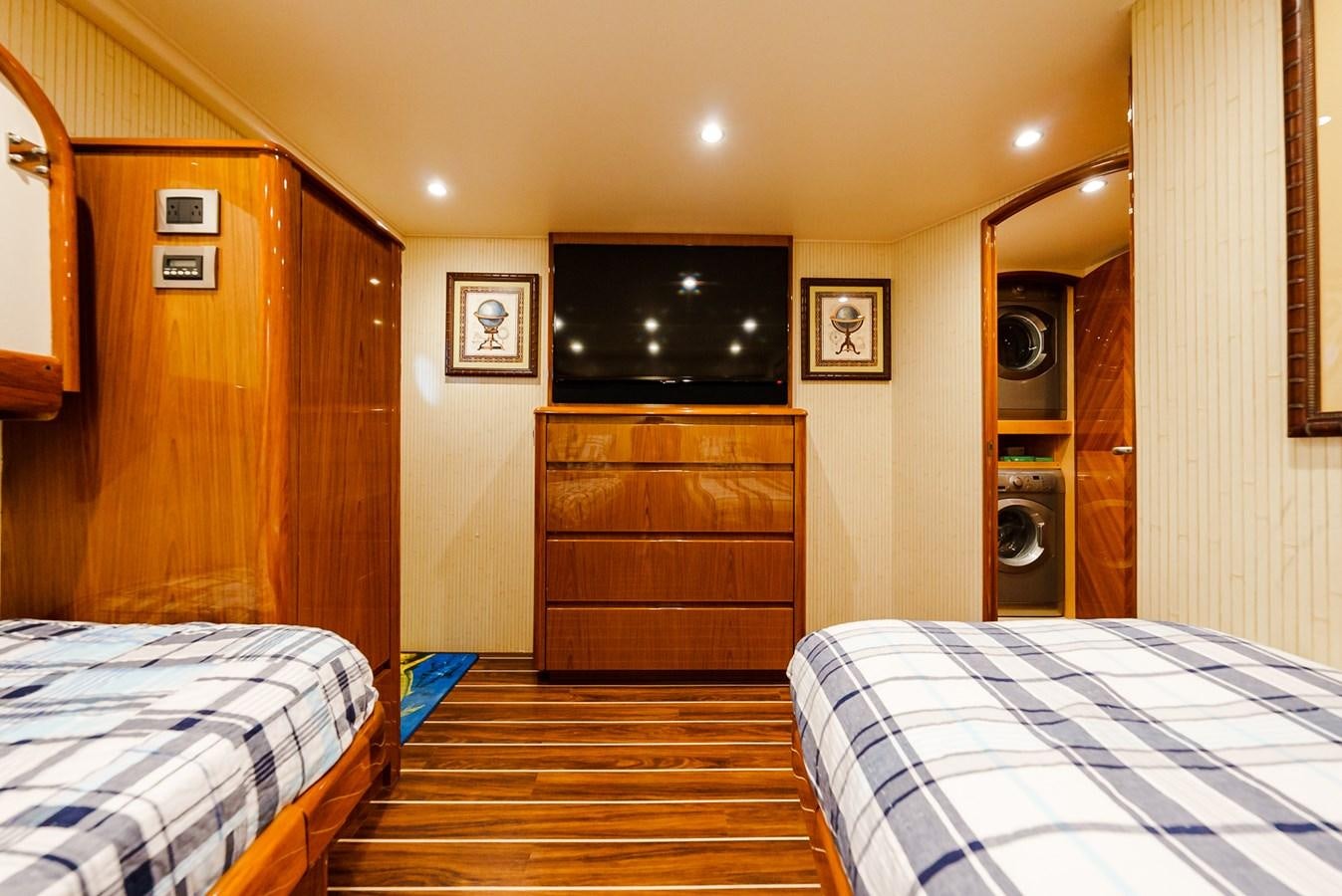 a bedroom with a bed and a television aboard PANACEA Yacht for Sale