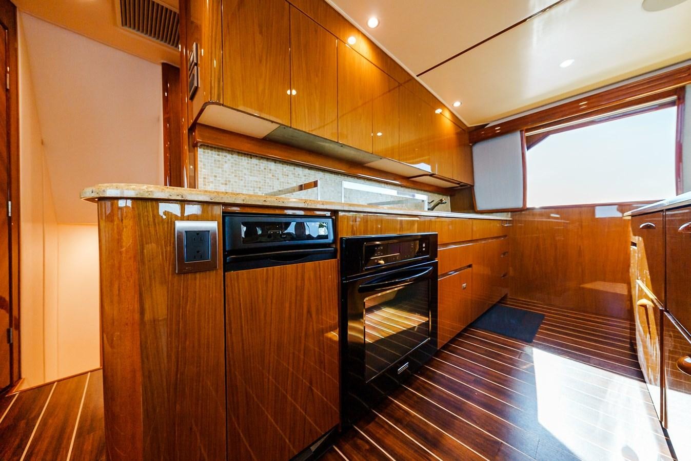 a kitchen with wooden cabinets aboard PANACEA Yacht for Sale