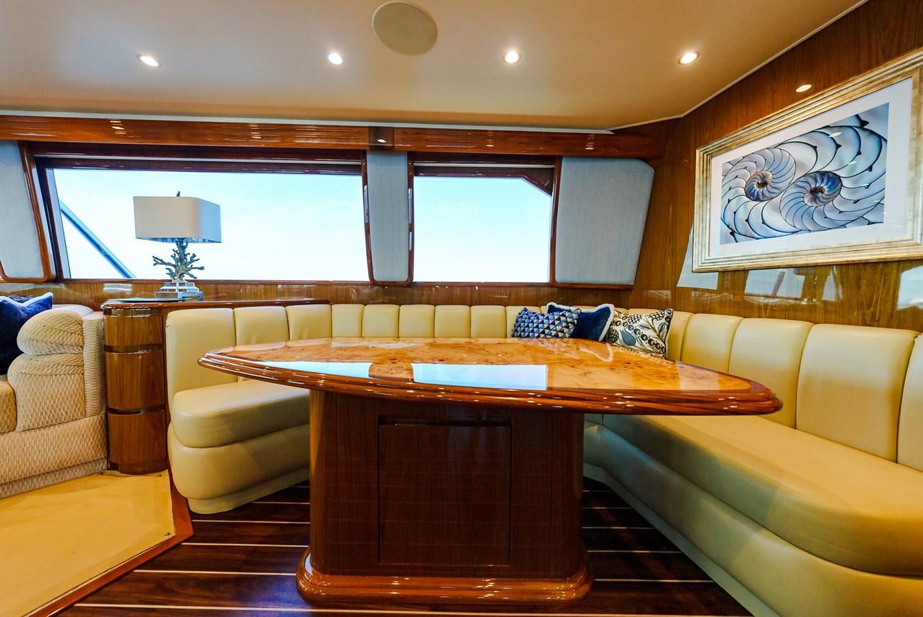 a room with a table and couch aboard PANACEA Yacht for Sale