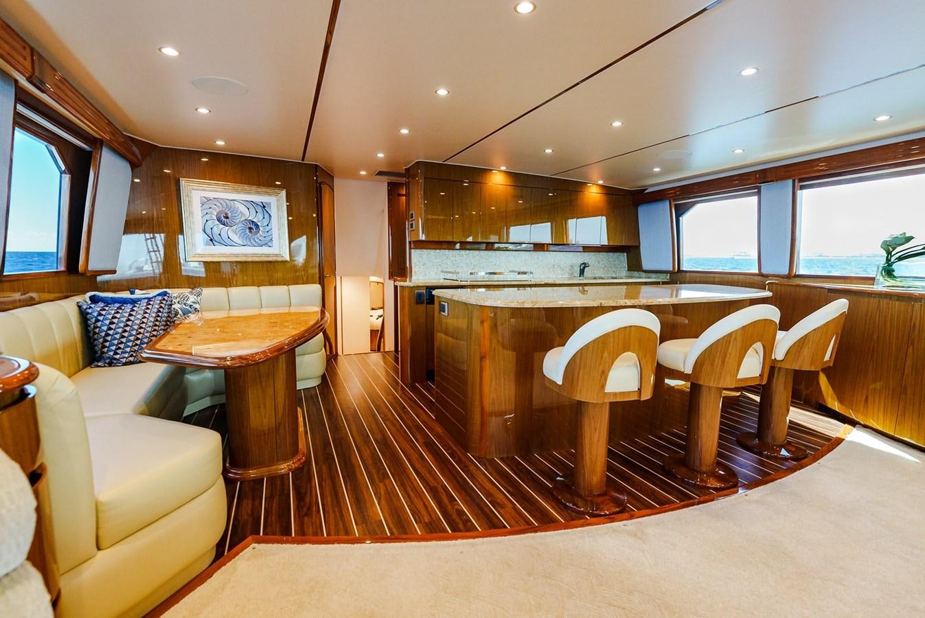 a large kitchen with a bar and chairs aboard PANACEA Yacht for Sale