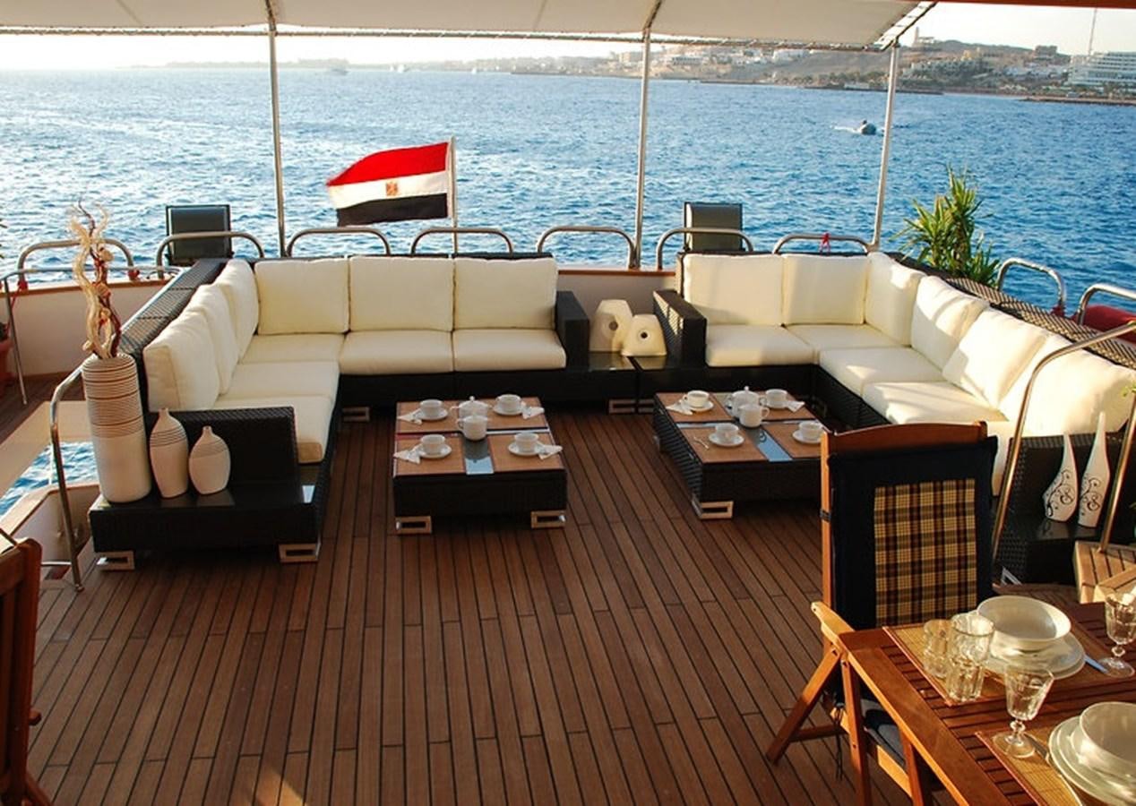a deck with a table and chairs on it aboard 36 M YATCH Yacht for Sale