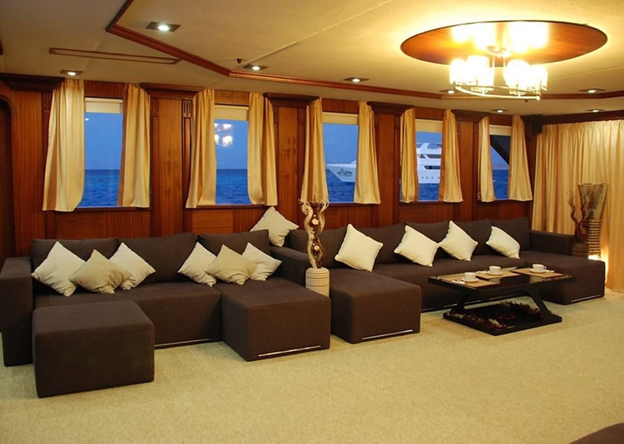 a large living room with black couches and a large window aboard 36 M YATCH Yacht for Sale
