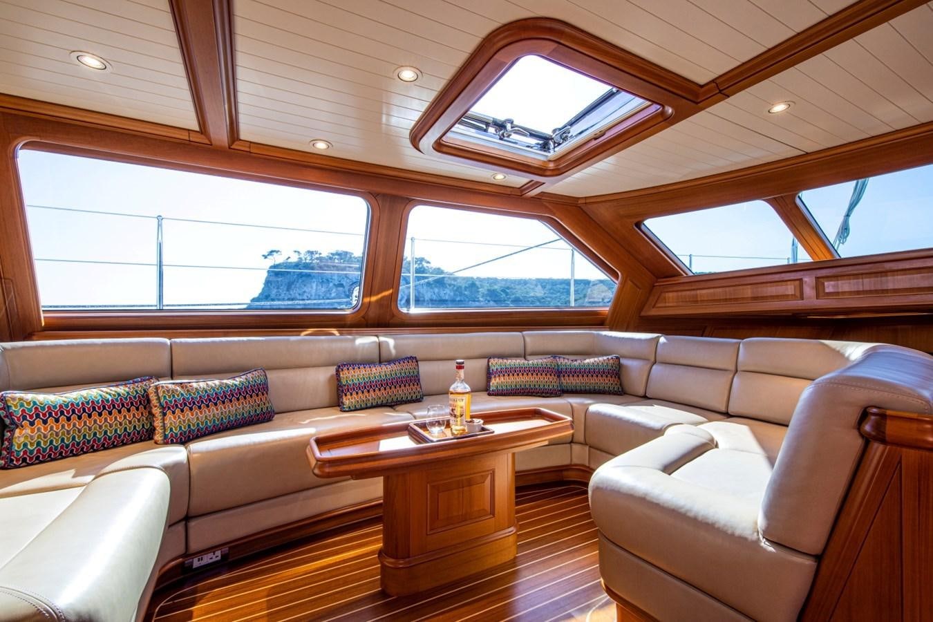 a room with a couch and a table aboard LEGEND Yacht for Sale
