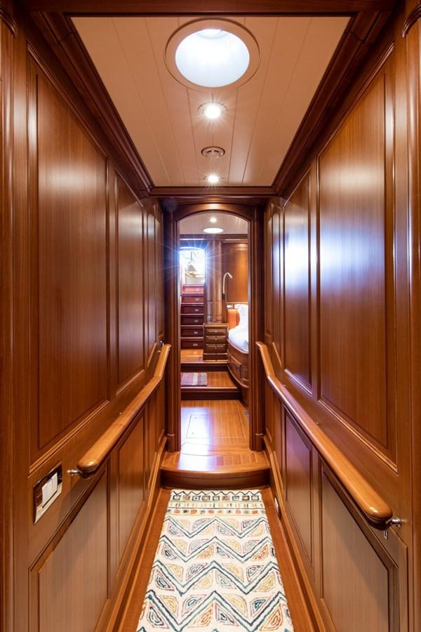 a long hallway with wooden doors aboard LEGEND Yacht for Sale