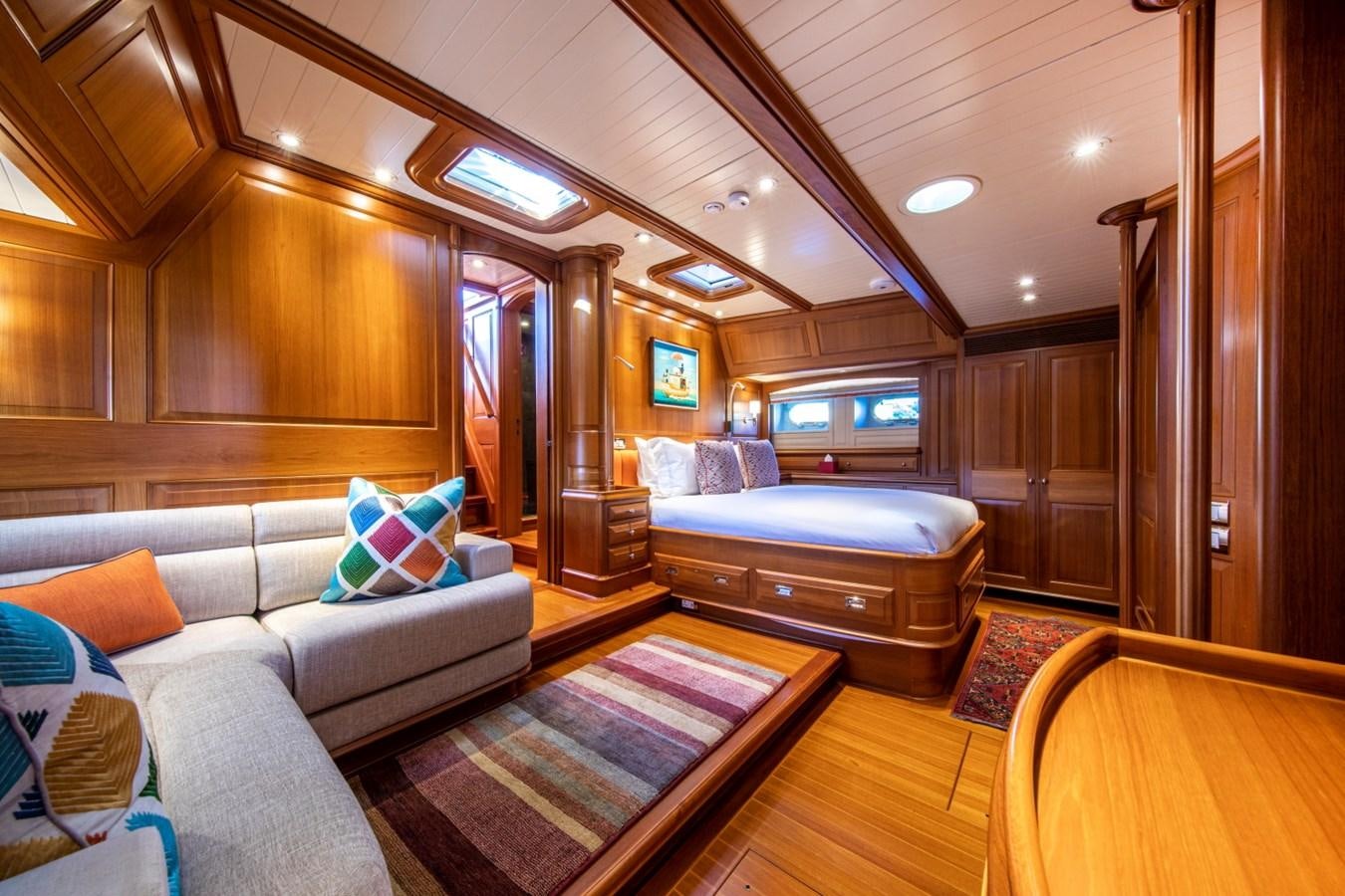 a living room with a couch and a tv aboard LEGEND Yacht for Sale