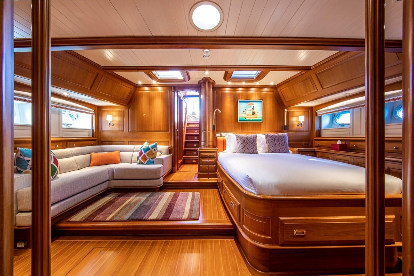 a room with a bed and a couch aboard LEGEND Yacht for Sale