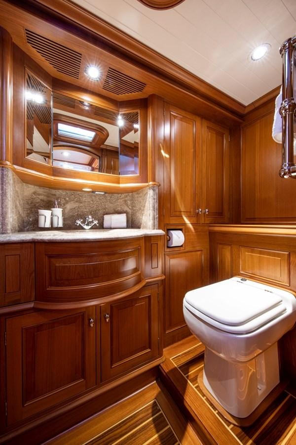 a bathroom with wooden cabinets aboard LEGEND Yacht for Sale