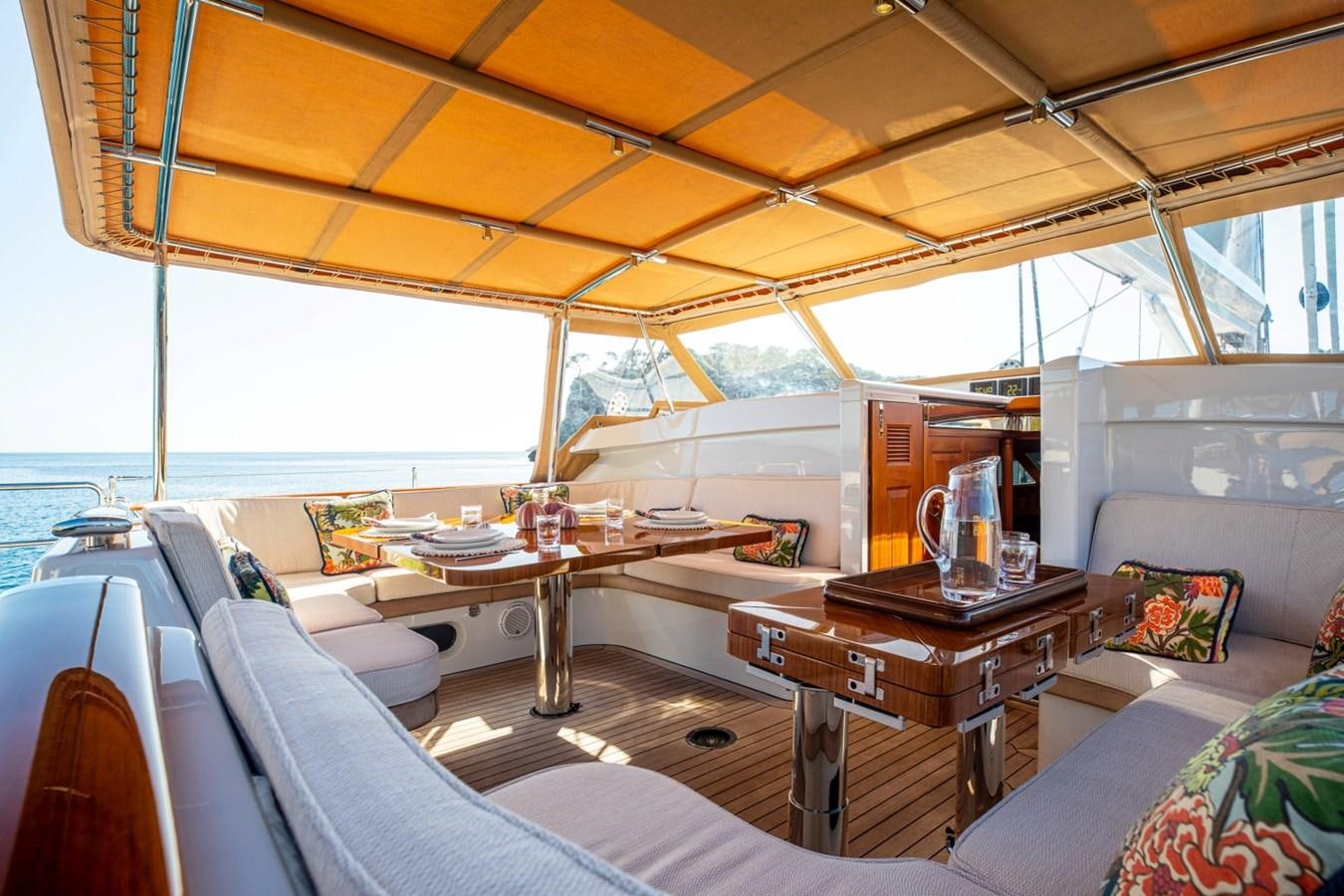 a room with a table and chairs aboard LEGEND Yacht for Sale
